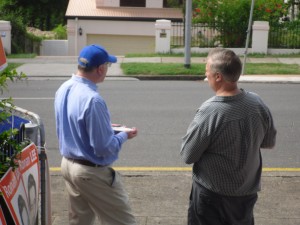 "Phil" talking to Senator George Brandis (left, in the LNP hat)
