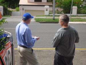 "Phil" talking to Senator George Brandis (left, in the LNP hat)